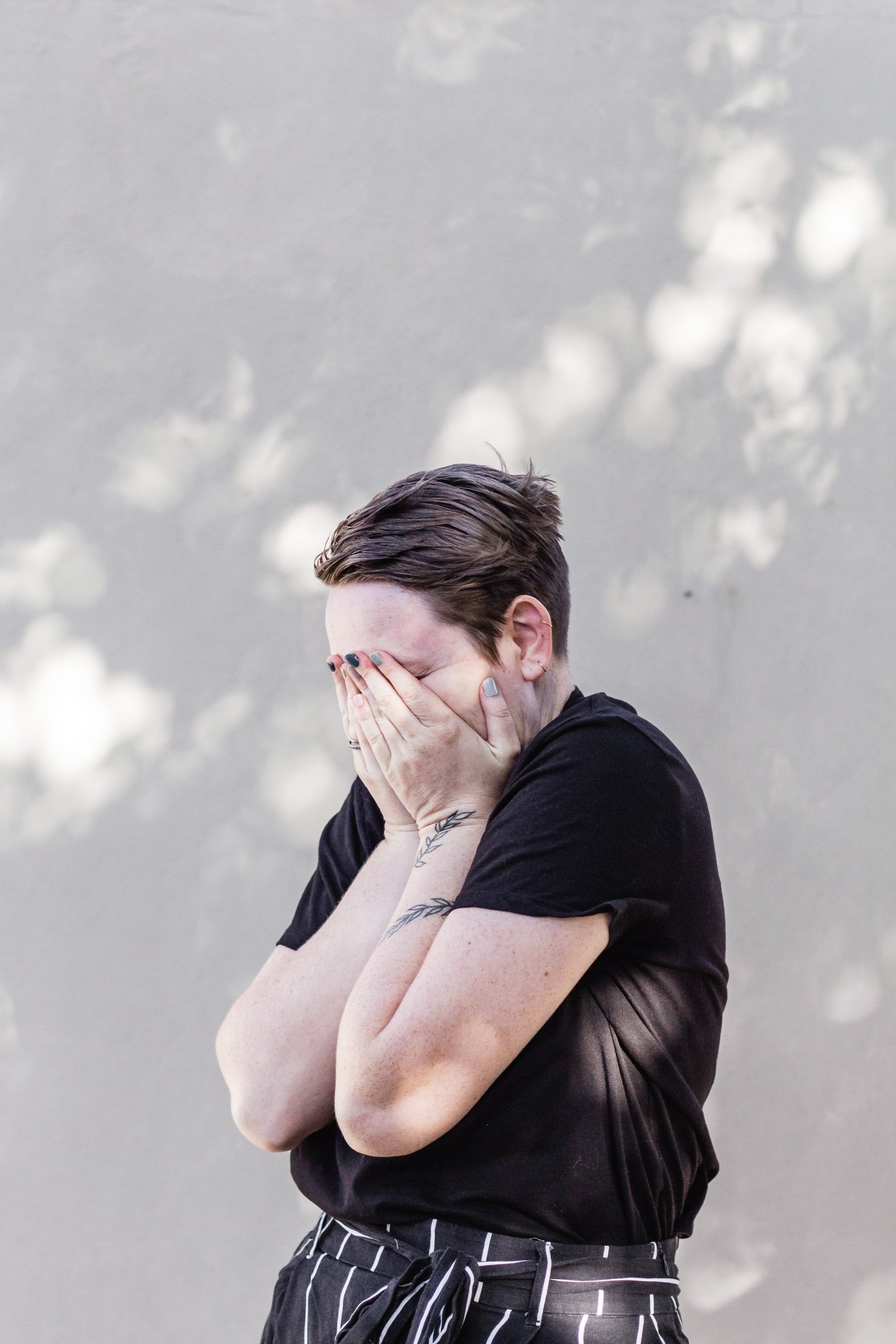 person covering face with hands